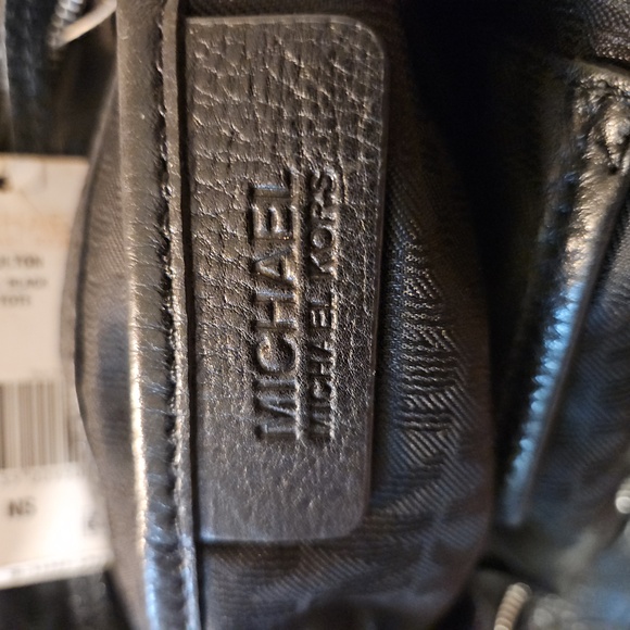 Micheal Kors satchel black all leather gold emblem accent.  It's roomy and nice. - Picture 7 of 8